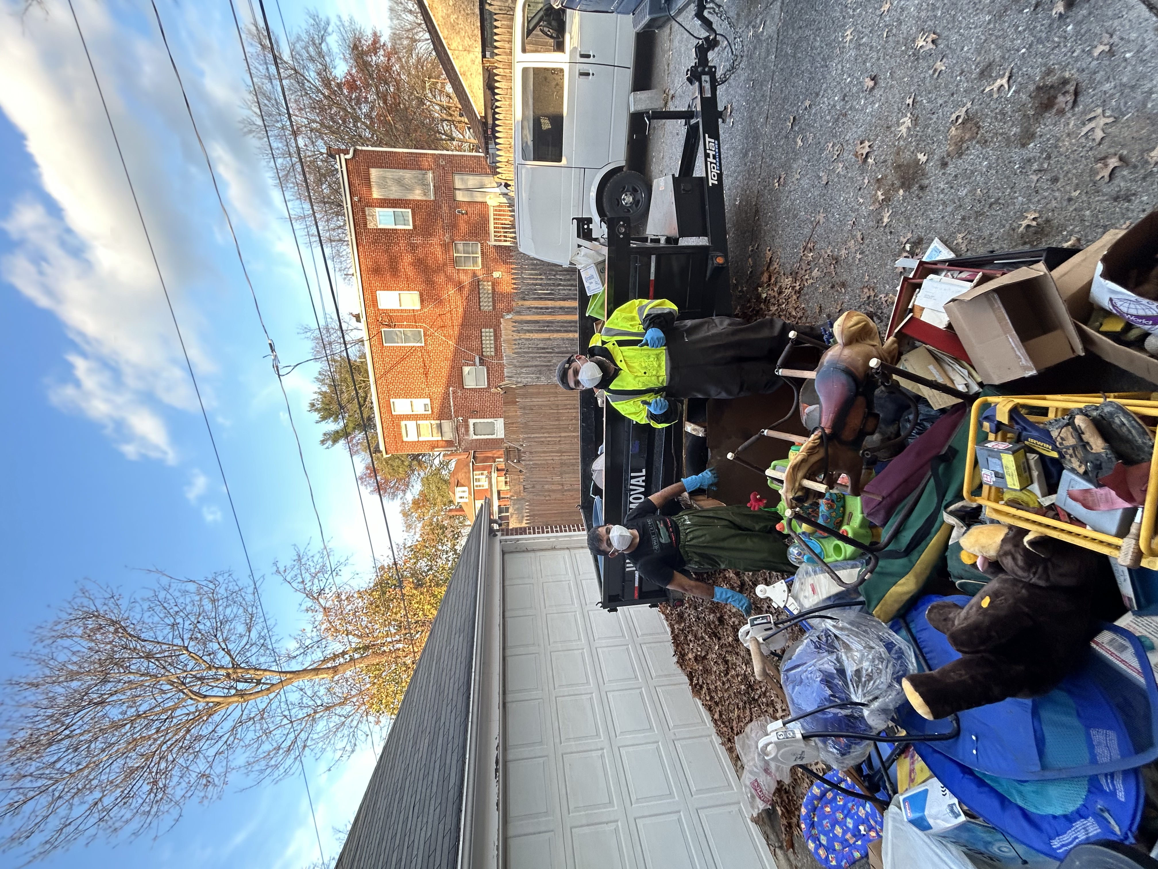 Junk Squad crew unloading a trailer at a Central PA junk removal job